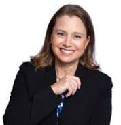 Woman smiling in front of a white backdrop.